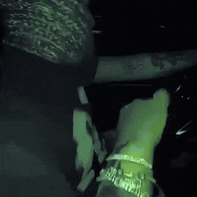 A Blurry Picture Of A Person 'S Face With A Green Light Behind Them GIF