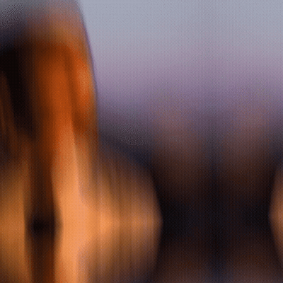 A Blurry Picture Of A Person 'S Face With A Purple Sky In The Background GIF