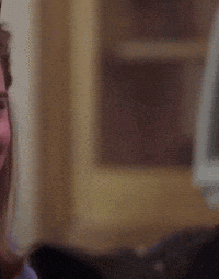 A Blurry Picture Of A Person 'S Face With A Shelf In The Background GIF