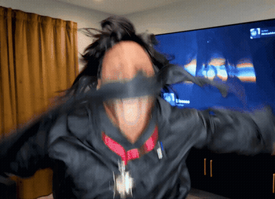 A Blurry Picture Of A Person 'S Face With A Tv In The Background That Says ' Netflix ' GIF