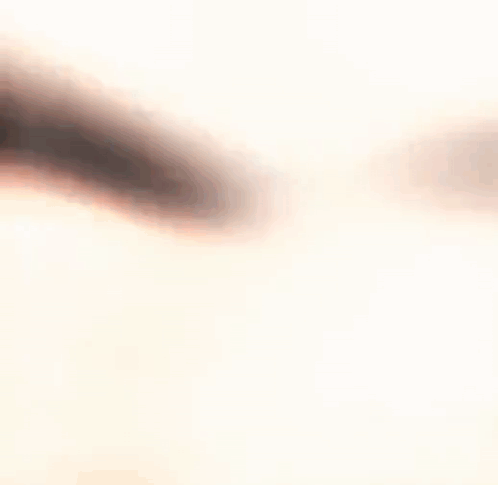 A Blurry Picture Of A Person 'S Face With A White Background . GIF