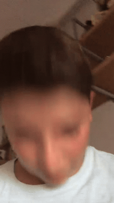 A Blurry Picture Of A Person 'S Face With A White Shirt On GIF