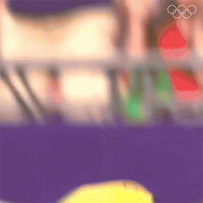 A Blurry Picture Of A Person 'S Face With The Olympic Rings In The Background GIF