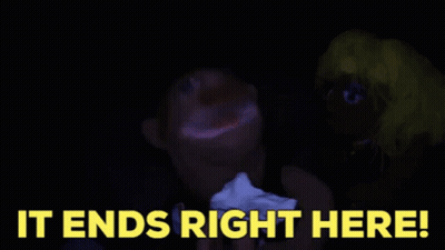 A Blurry Picture Of A Person 'S Face With The Words `` It Ends Right Here '' In Yellow Letters . GIF