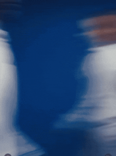 A Blurry Picture Of A Person 'S Torso In A Blue Background GIF