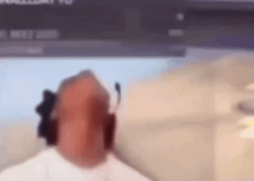 A Blurry Picture Of A Person Sitting In Front Of A Computer Screen GIF
