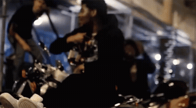 A Blurry Picture Of A Person Sitting On A Bike GIF