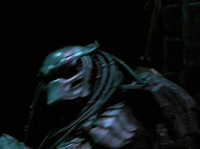 A Blurry Picture Of A Person Standing In A Dark Room With A Few Lights Behind Them GIF