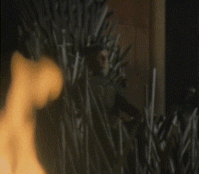 A Blurry Picture Of A Person Standing In A Field Of Tall Grass . GIF