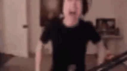 A Blurry Picture Of A Person Standing In A Living Room . GIF