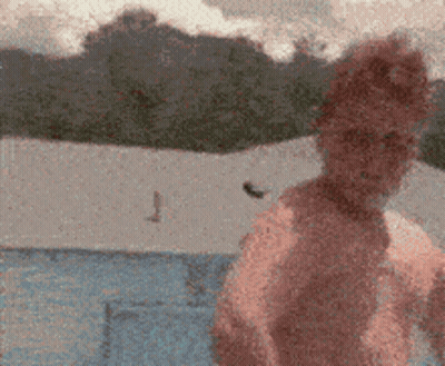 A Blurry Picture Of A Person Standing In Front Of A Blue Tent GIF
