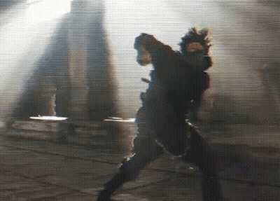 A Blurry Picture Of A Person Standing In Front Of A Building . GIF