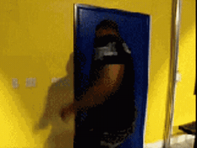 A Blurry Picture Of A Person Standing In Front Of A Door GIF