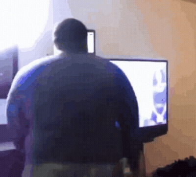 A Blurry Picture Of A Person Standing In Front Of A Tv GIF