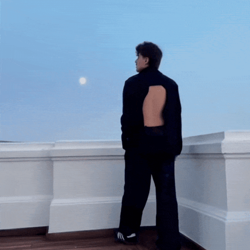 A Blurry Picture Of A Person Standing In Front Of A Window GIF