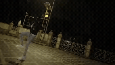 A Blurry Picture Of A Person Standing Next To A Table . GIF