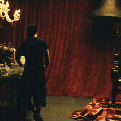 A Blurry Picture Of A Person Standing On A Red Carpet GIF