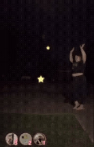 A Blurry Picture Of A Person Standing On A Sidewalk With A Star In The Background GIF