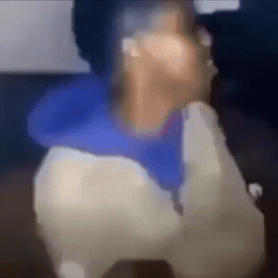 A Blurry Picture Of A Person Talking On A Phone . GIF