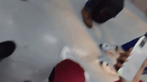A Blurry Picture Of A Person Using A Tablet Computer GIF