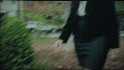 A Blurry Picture Of A Person Walking Down A Sidewalk GIF