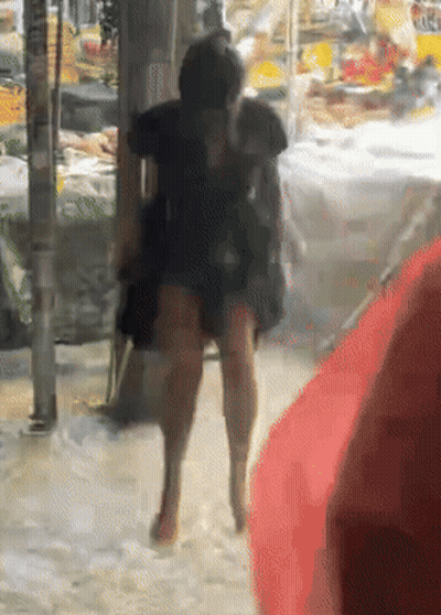 A Blurry Picture Of A Person Walking In The Rain GIF