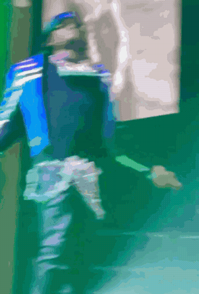 A Blurry Picture Of A Person Walking On A Green Floor GIF
