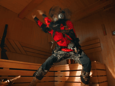 A Blurry Picture Of A Person Wearing Headphones And A Red Jacket With The Letter A On It GIF
