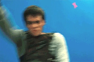 A Blurry Picture Of A Person With A Blue Background And A Pink Object In The Background GIF