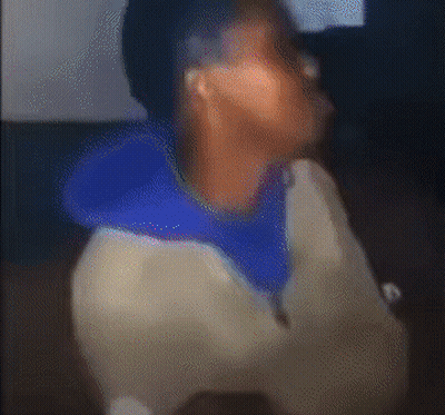 A Blurry Picture Of A Person With A Blue Hoodie On GIF