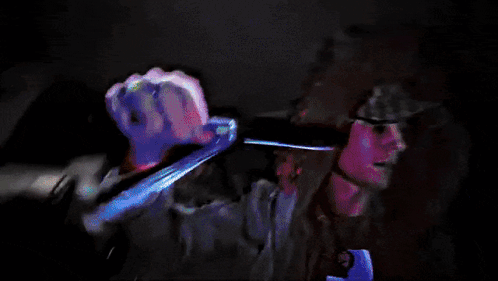 A Blurry Picture Of A Person With Their Hands Painted Red GIF