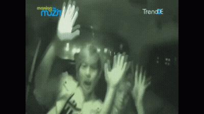 A Blurry Picture Of A Person With Their Hands Up In Front Of A Sign That Says Making The Most GIF