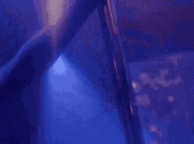 A Blurry Picture Of A Pole Dancer In A Club GIF