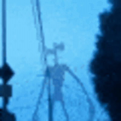 A Blurry Picture Of A Siren Head Standing Next To A Pole . GIF