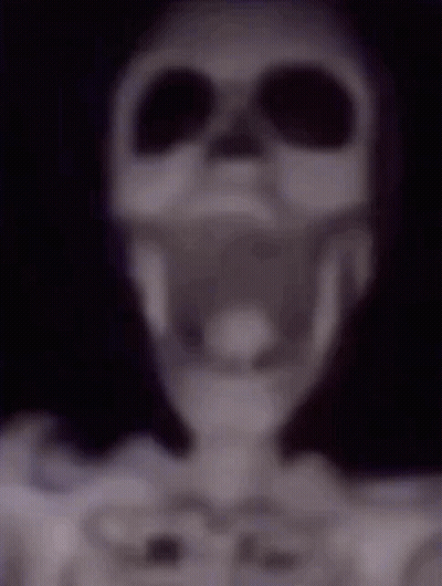 A Blurry Picture Of A Skeleton Wearing Headphones And Sunglasses . GIF