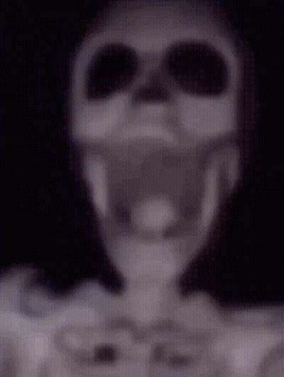 A Blurry Picture Of A Skeleton Wearing Sunglasses And A Skull . GIF