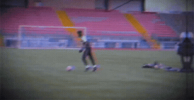 A Blurry Picture Of A Soccer Field With A Yellow Pole GIF