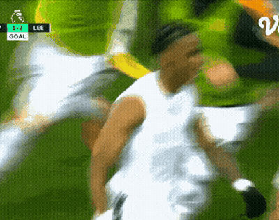 A Blurry Picture Of A Soccer Game With The Score 1-2 Lee GIF