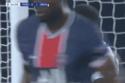 A Blurry Picture Of A Soccer Player Standing In Front Of A Goal During A Game . GIF