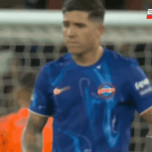 A Blurry Picture Of A Soccer Player Wearing A Blue Shirt That Says Pepsi GIF