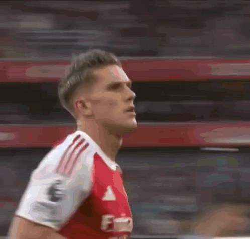 A Blurry Picture Of A Soccer Player Wearing A Red And White Adidas Jersey GIF