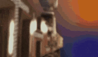 A Blurry Picture Of A Statue With A Sunset In The Background . GIF