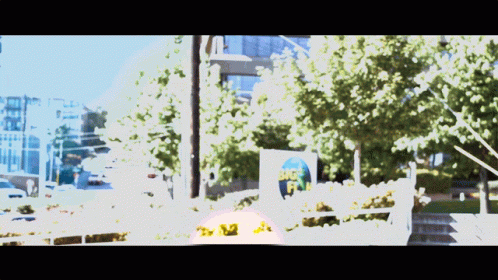 A Blurry Picture Of A Street With A Sign That Says Big Fish On It GIF