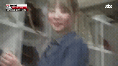 A Blurry Picture Of A Woman In A Blue Shirt Standing In A Kitchen . GIF