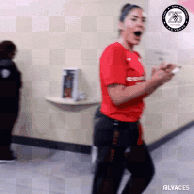 A Blurry Picture Of A Woman In A Red Shirt And Black Pants With The Hashtag @Lvaches GIF
