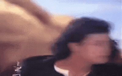 a blurry picture of a woman 's face in a black jacket .