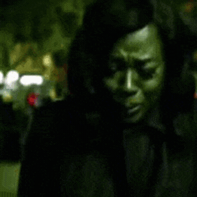 A Blurry Picture Of A Woman 'S Face In A Dark Room GIF