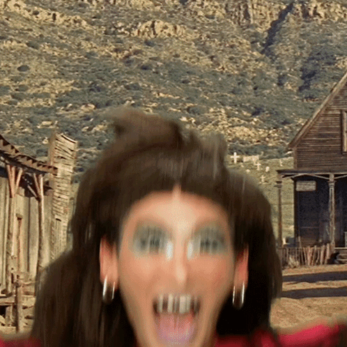 A Blurry Picture Of A Woman 'S Face With A Sign In The Background That Says ' Ranch ' On It GIF