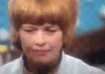 A Blurry Picture Of A Woman 'S Face With Her Eyes Closed . GIF