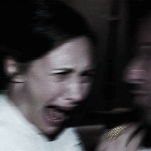 A Blurry Picture Of A Woman Screaming With Her Mouth Wide Open GIF